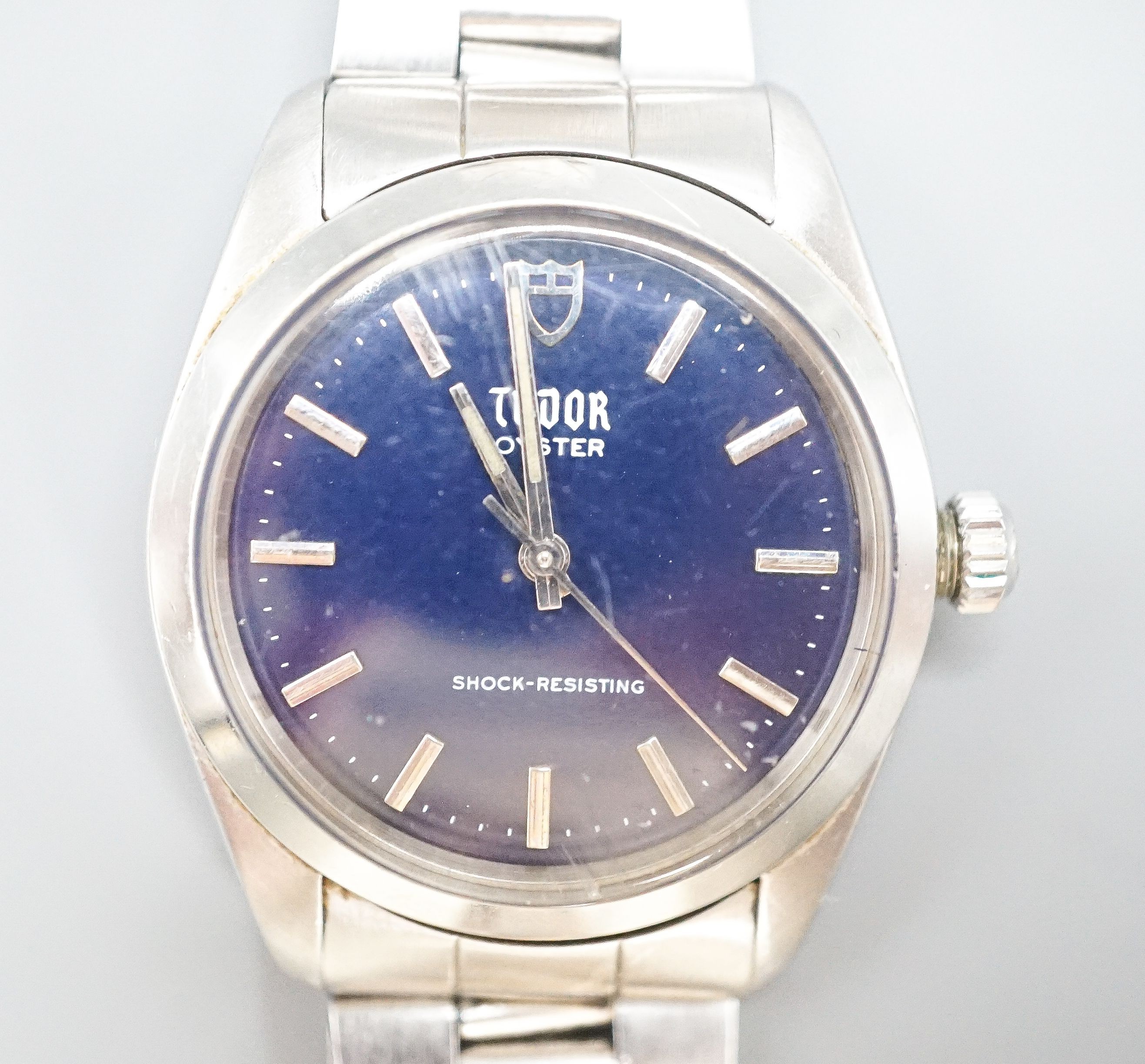 A gentleman's stainless steel Tudor Oyster manual wind wrist watch, with blue dial, on Rolex bracelet, case diameter 34mm, no box or papers.